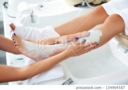 Aplying nourishing moisturizer mask woman legs Aplying nourishing moisturizer mask woman legs 134904587