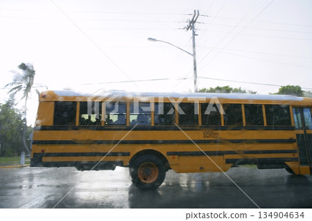Blurry motion road with yellow school bus, hurricane storm rain Blurry motion road with yellow school bus, hurricane storm rain 134904634