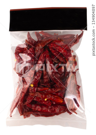 Roasted chilies in a plastic bag isolated on white background Roasted chilies in a plastic bag isolated on white background 134904897