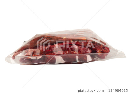 Roasted chilies in a plastic bag isolated on white background 134904915
