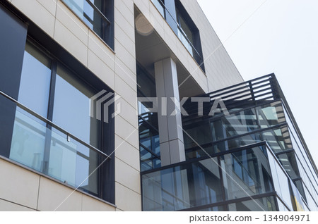 facade of a modern office building with large glass windows 134904971