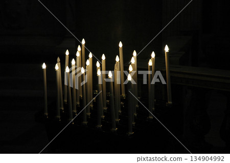 set of candles as an offering in a place of worship set of candles as an offering in a place of worship 134904992