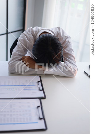 Businessman experiencing stressat work due to heavy workloads, financial worries, and the pressure of responsibility. 134905030