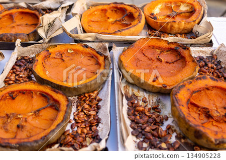 A pile of pumpkin pies with a paper wrapper on top A pile of pumpkin pies with a paper wrapper on top 134905228