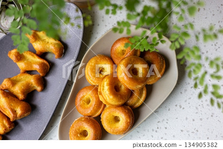 Golden mini donut-shaped pound cake on an oval plate Golden mini donut-shaped pound cake on an oval plate 134905382