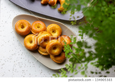 Golden mini donut-shaped pound cake on an oval plate Golden mini donut-shaped pound cake on an oval plate 134905383