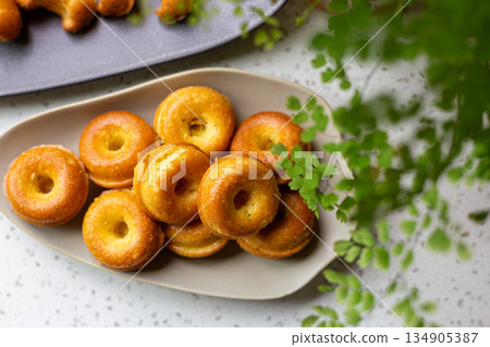 Golden mini donut-shaped pound cake on an oval plate 134905387