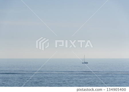 sailing ship with sails lowered, the horizon in the background and the sea calm. 134905400
