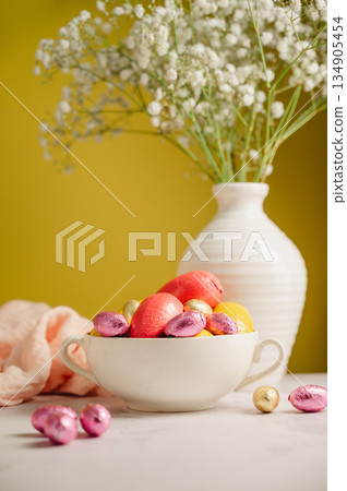 Easter cake with chocolate easter eggs, gypsophila flowers. Spring holiday background. Easter cake with chocolate easter eggs, gypsophila flowers. Spring holiday background. 134905454