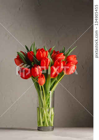 Spring flowers in a vase. A bouquet of fresh red tulips, birthday or easter background Spring flowers in a vase. A bouquet of fresh red tulips, birthday or easter background 134905455