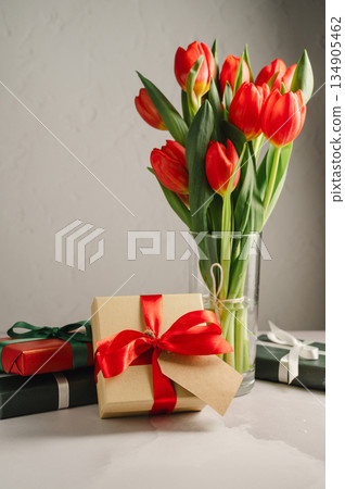 Red tulips with gift boxes. Easter holiday. Bright background 134905462