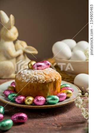 Easter spring holiday background. Cake with chocolate easter eggs, gypsophila flowers and bunny 134905463