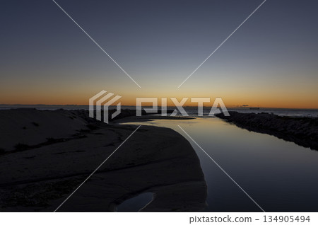 image of the sunrise on the seashore by the mouth of the river image of the sunrise on the seashore by the mouth of the river 134905494
