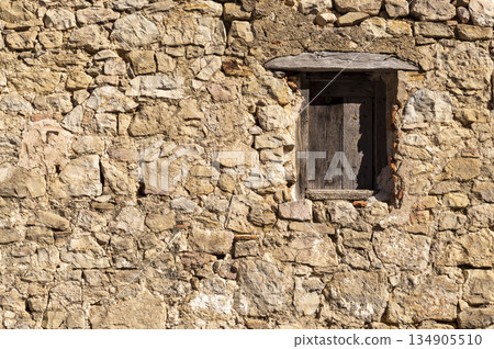 wooden window recessed in a stone wall wooden window recessed in a stone wall 134905510