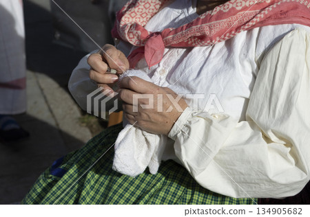 human hands sewing with metal thimble 134905682
