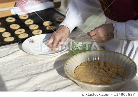 woman's hands preparing dough to make sweet rolls with typical costumes woman's hands preparing dough to make sweet rolls with typical costumes 134905687