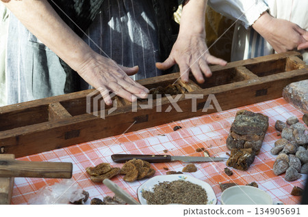 close-up of a woman's hands preparing sweet fig bread in a traditional manner 134905691