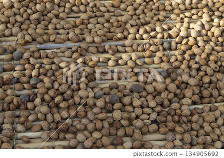 almonds drying in the open air on a hurdle 134905692