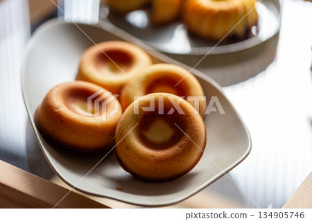 Golden handmade pastries with berry fillings, Gugelhupf and donut-shaped pound cakes Golden handmade pastries with berry fillings, Gugelhupf and donut-shaped pound cakes 134905746