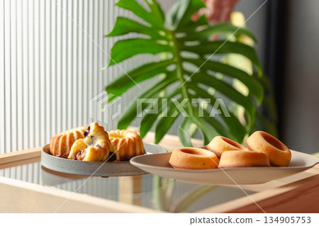 Golden handmade pastries with berry fillings, Gugelhupf and donut-shaped pound cakes Golden handmade pastries with berry fillings, Gugelhupf and donut-shaped pound cakes 134905753