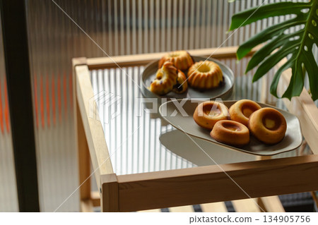 Golden handmade pastries with berry fillings, Gugelhupf and donut-shaped pound cakes Golden handmade pastries with berry fillings, Gugelhupf and donut-shaped pound cakes 134905756