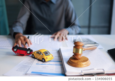 Justice for car accidents with gavel and car model on the table concept for insurance claim, court hearing or personal injury lawsuit settlement. Justice for car accidents with gavel and car model on the table concept for insurance claim, court hearing or personal injury lawsuit settlement. 134906055