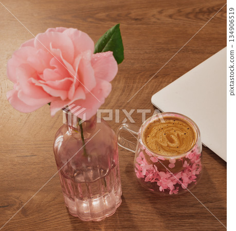 morning work routine: fresh coffee and beautiful rose decorating the start of a digital day 134906519