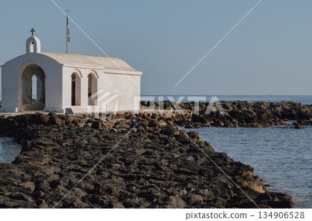 Seaside chapel view with stone path in Georgioupolis Crete Seaside chapel view with stone path in Georgioupolis Crete 134906528