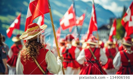 Swiss National Day street festival with a crowd in national costumes waving flags. A vibrant celebration of Swiss heritage, ideal for tourism promotions or cultural event coverage 134906598