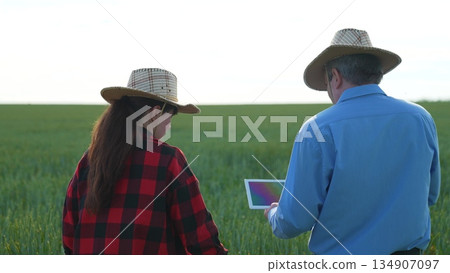 Field inspection with tablet, Agricultural progress, High-tech farmers, Future of farming, Modern fieldwork tools, Farm digitalization, Explorers of agriculture, Farming in the 21st century, Efficient 134907097