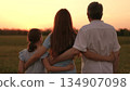 Happy family, father mother child hugging sunset, girl hugging parents man woman sunset, people outdoors nature, countryside family love, tender evening light, tender countryside moment, heartfelt 134907098