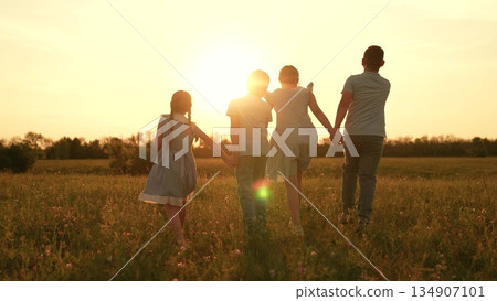 Happy children run towards sunset, girl boy holding hands run play, fun summer holidays, children recreation, childhood wonder moments, learning cooperation skills, sunset meadow walk, peaceful Happy children run towards sunset, girl boy holding hands run play, fun summer holidays, children recreation, childhood wonder moments, learning cooperation skills, sunset meadow walk, peaceful 134907101