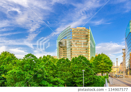 Representation of the European Commission Charlemagne building behind green trees on Rue de la Loi Wetstraat Law Street in European Quarter of Brussels city, Brussels-Capital Region, Belgium 134907577