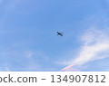 Airplane takes off into a blue sky 134907812