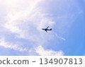 Airplane takes off into a blue sky 134907813