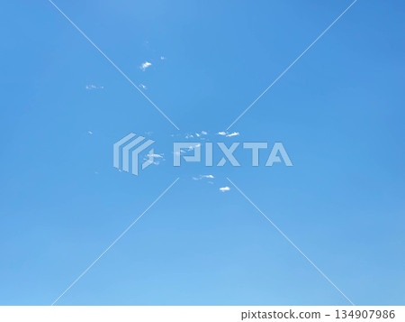 Spring sky. The background is a bright blue sky with small clusters of white cirrus clouds Spring sky. The background is a bright blue sky with small clusters of white cirrus clouds 134907986