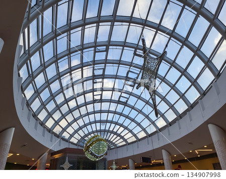 Oval ceiling with a Christmas star and a New Year's ball in a supermarket Oval ceiling with a Christmas star and a New Year's ball in a supermarket 134907998