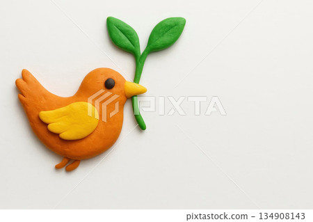 Orange bird with a plasticine branch on a white background. Space for text. Orange bird with a plasticine branch on a white background. Space for text. 134908143