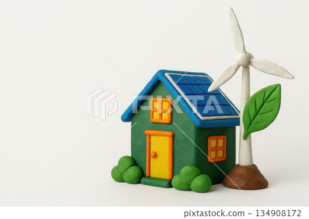 Eco-house with solar panels and a windmill made of plasticine. Space for text. 134908172