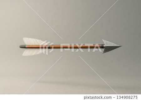 A lone arrow in the air against a neutral background. Space for text. A lone arrow in the air against a neutral background. Space for text. 134908275