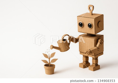 A cardboard robot watering a paper plant. Space for text. A cardboard robot watering a paper plant. Space for text. 134908353