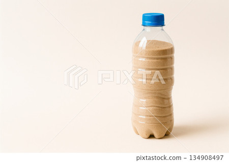 A plastic bottle filled with sand. Space for text. A plastic bottle filled with sand. Space for text. 134908497