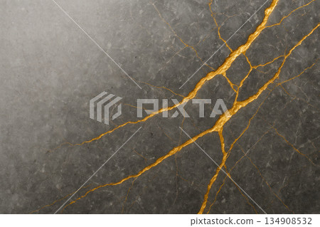 Cracks with gold veins on the dark stone. Space for text. 134908532