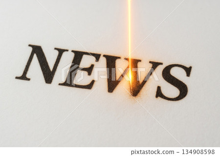 The inscription NEWS is burned with a laser. Space for text. 134908598