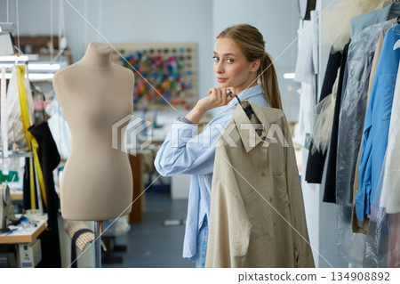 Emerging fashion professional presents environmentally sustainable jacket sample Emerging fashion professional presents environmentally sustainable jacket sample 134908892
