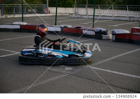 A thrilling go-karting scene featuring a racer focused on the track 134908924