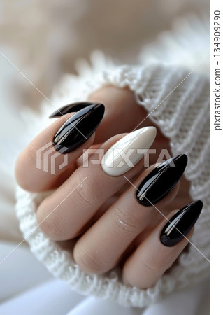 Closeup of black and white manicured nails with nail polish 134909290
