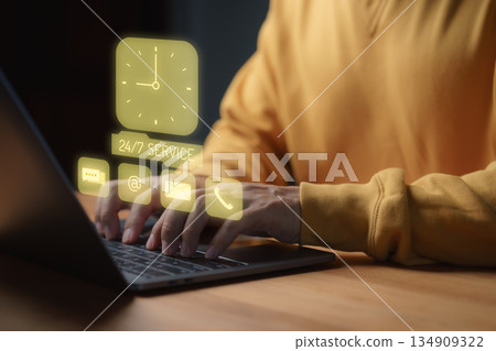 Hands typing on laptop with holographic icons for 24/7 service, chat, email, and phone support, symbolizing online customer service, digital communication, and business assistance. Hands typing on laptop with holographic icons for 24/7 service, chat, email, and phone support, symbolizing online customer service, digital communication, and business assistance. 134909322