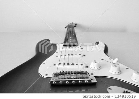 Black and white view of the neck from the body side of an electric guitar Black and white view of the neck from the body side of an electric guitar 134910519