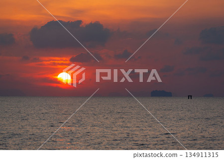 Sunrise in the morning at Saphanhin public beach, Phuket, Thailand. Sunrise in the morning at Saphanhin public beach, Phuket, Thailand. 134911315